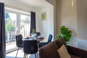 a living room with a table and chairs and a window at Wolverhampton 4 Bed home, Sleeps 7, Parking in Tettenhall