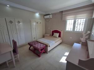 a bedroom with a bed and a chair and windows at Villa lucky in Hammamet +47 photos