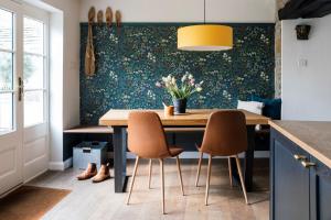 a dining room with a table and two chairs at Sweet Pea Cottage in Tideswell +27 photos