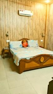 a dog laying in a bed in a room at Hotel Sandalwood in Amritsar