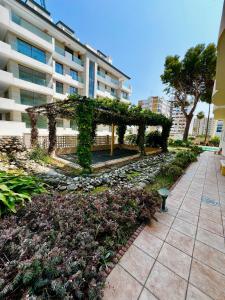 a pergola covered in ivy next to a building at 2 Bedroom Apartment in Puerto Marina in Benalmadena Costa