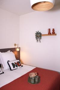 a bedroom with a white bed with a red rug at Au Coeur du marché - Hyper centre Dijon - Terrasse in Dijon +16 photos
