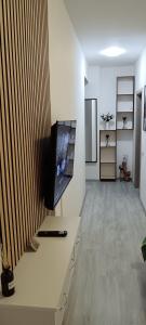 a living room with a flat screen tv on a table at Skyline Apart 1 Militari Residence in Roşu