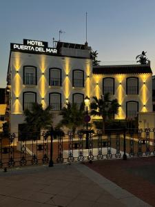 a hotel with lights on the side of a building at Hotel Puerta del Mar - Adults Recommended in Nerja