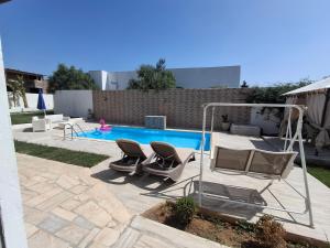a swimming pool with two lounge chairs and a swimming pool at Villa lucky in Hammamet