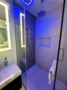 a bathroom with a shower and a sink and a glass shower stall at STAR KLCC By Comfort Hospitality in Kuala Lumpur