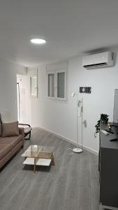 マラガにあるApartamento con terraza sol y montaña tranquilidadのソファとコーヒーテーブルのあるリビングルーム