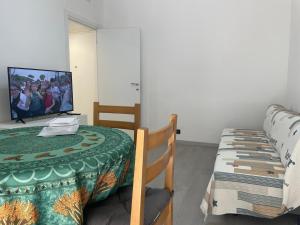 a dining room with a table and a television at Casa Gelsomina apartment in Rapallo