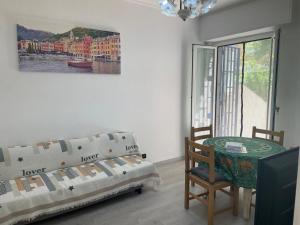 a room with a bed and a table and a window at Casa Gelsomina apartment in Rapallo
