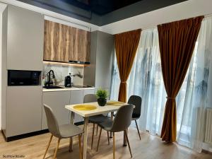 a kitchen and dining room with a table and chairs at Seaview Studio in Năvodari