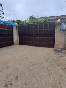 a large black metal gate in a yard at Sifa Stays in Ongata Rongai 