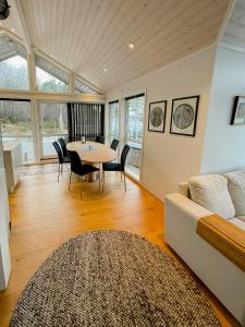 a living room with a table and a couch at Seaside Cabin With Private Pier In Eidsvåg in Eidsvåg