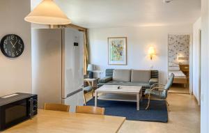 a living room with a couch and a table at Schönes Zuhause In Hokjönköpingskillingaryd in Svenstorp