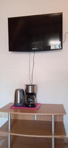 a microwave on top of a wooden table at Balaton White House in Vonyarcvashegy