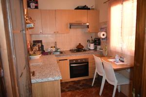 a small kitchen with a counter and a table and chairs at Marrakech Sakan Annakhil im6 n31 in Marrakesh