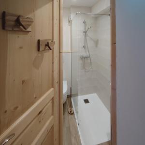 a bathroom with a shower and a toilet and a sink at Le Bellacha in La Léchère +11 photos