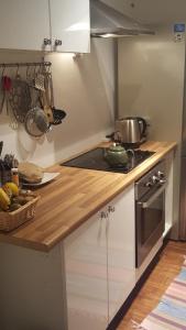 a kitchen with a counter top with a pot on a stove at Flat in Hammersmith - Close to tube station in London
