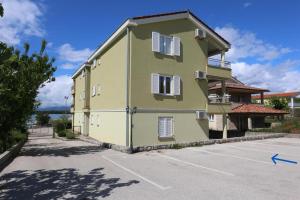 a building with a parking lot in front of it at Apartment Sonja in Klimno