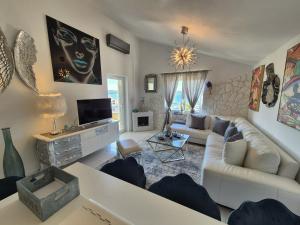 a living room with a couch and a tv at Apartment Sonja in Klimno