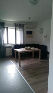 a living room with a table and a couch at Apartment Aleksandar in Mošćenička Draga +3 photos