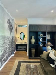 a living room with a couch and a mirror at Saige House - Room in Shared Villa in Canggu