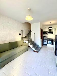 a living room with a couch and a kitchen at MILAN Senago Mantica 8 in Senago