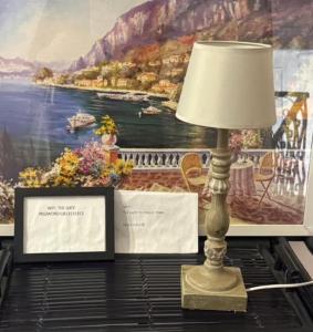 a lamp sitting on a table next to a painting at The Gate to Cinque terre in La Spezia