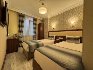 a hotel room with two beds and a window at Hotel Bulvar Istanbul in Istanbul +22 photos