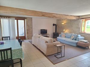 a living room with a couch and a table at Gites Les Grandes Ecures in Mons