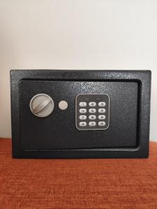a black remote control sitting on top of a table at Stressfree Suite in Vila Nova de Milfontes