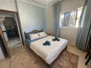 a bedroom with a bed with two towels on it at Villa MANSOURA avec piscine privative in Driouch +49 photos