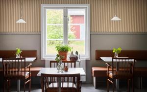 a restaurant with two tables and a window at Stay North Matri House Edla in Mathildedal
