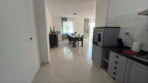 a kitchen and dining room with a table in it at La casa di Flo in Solanas