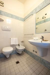 a bathroom with a toilet and a sink at Hotel Paola Garden in Rimini +30 photos