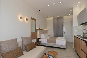 a living room with a couch and a bed in a room at Morpheas Rooms in Palaiochora