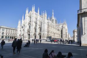 a group of people standing in front of a large building at Sweett - Mazzini in Milan