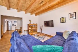 a large blue couch in a living room at Mountain Safari Garmisch - Spacious, scenic and steps from adventure in Garmisch-Partenkirchen