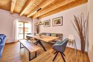 a living room with a table and a couch at Mountain Safari Garmisch - Spacious, scenic and steps from adventure in Garmisch-Partenkirchen