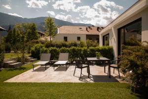 a patio with chairs and a table on a house at Agriturismo Insolito in Terlano