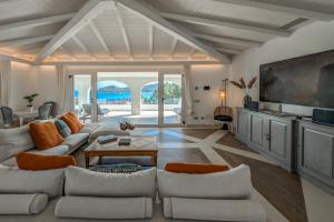 a living room with a couch and a table at Villa Bianca in Villasimius