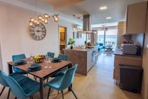 a kitchen and dining room with a table and chairs at Bugibba - Central Luxury Seafront, only for family in St. Paul's Bay