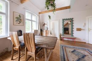 a dining room with a wooden table and chairs at Design Apartments - Innenstadt, Apt 2 in Potsdam