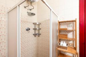 a shower with a glass door in a bathroom at La casa di Bebe in Vernole +22 photos