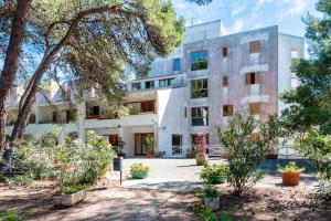 an exterior view of a building with trees at La casa di Bebe in Vernole