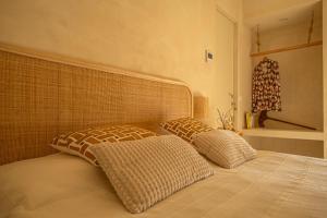 two pillows sitting on a bed in a bedroom at Tenuta le Menadi in Noto
