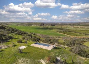 an overhead view of a field with a swimming pool at Tenuta le Menadi in Noto