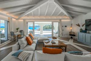 a living room with a couch and a table at Villa Bianca in Villasimius