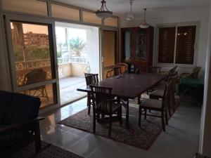 a dining room with a table and chairs and a balcony at Heaven on Earth in Alexandria