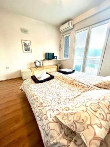 a large bed in a room with a large window at A&M Apartments in Ohrid