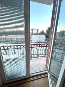 a view of a balcony from a window with blinds at A&M Apartments in Ohrid